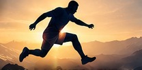 A runner leaping forward across a mountain landscape.